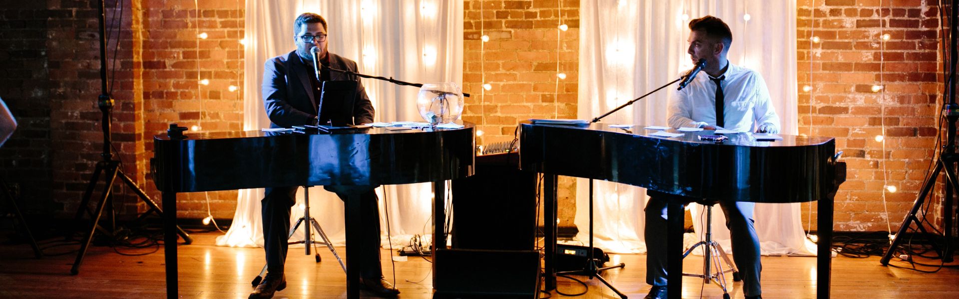 Brick and lights background with two pianists Dueling